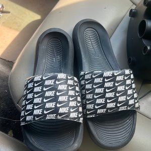 A pair of Nike slides size 11